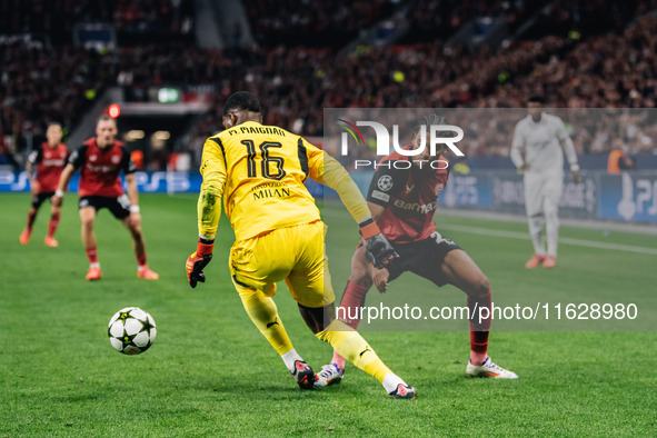 Amine Adli of Bayer 04 Leverkusen and Mike Maignan of AC Milan are in action during the UEFA Champions League 2024/25 League Phase MD2 match...