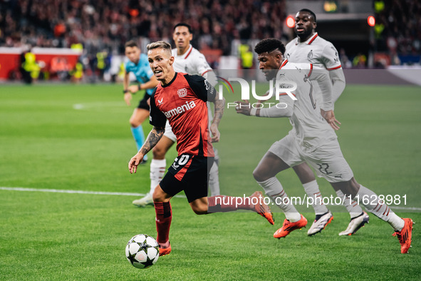 Alejandro Grimaldo of Bayer 04 Leverkusen and Emerson of AC Milan are in action during the UEFA Champions League 2024/25 League Phase MD2 ma...