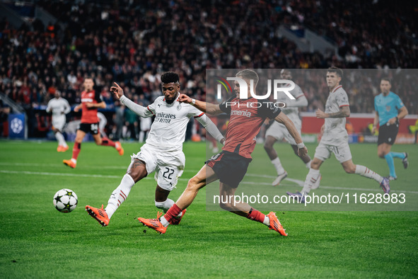 Florian Wirtz of Bayer 04 Leverkusen and Emerson of AC Milan are in action during the UEFA Champions League 2024/25 League Phase MD2 match b...