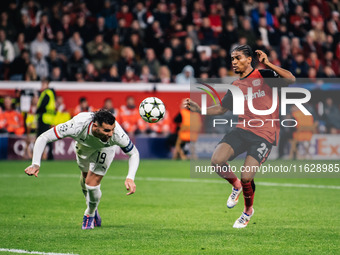 Amine Adli of Bayer 04 Leverkusen and Theo Hernandez of AC Milan are in action during the UEFA Champions League 2024/25 League Phase MD2 mat...