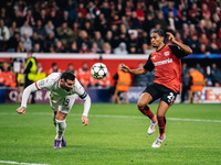 Amine Adli of Bayer 04 Leverkusen and Theo Hernandez of AC Milan are in action during the UEFA Champions League 2024/25 League Phase MD2 mat...