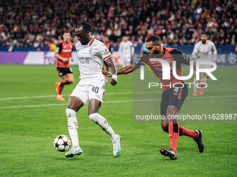 Tammy Abraham of AC Milan and Jonathan Tah of Bayer 04 Leverkusen are in action during the UEFA Champions League 2024/25 League Phase MD2 ma...