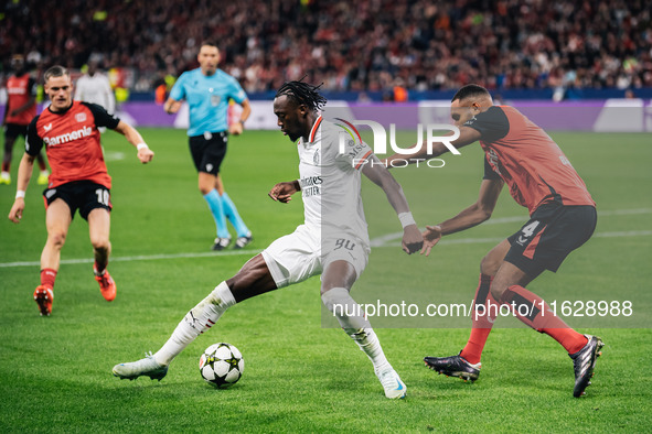 Tammy Abraham of AC Milan and Jonathan Tah of Bayer 04 Leverkusen are in action during the UEFA Champions League 2024/25 League Phase MD2 ma...