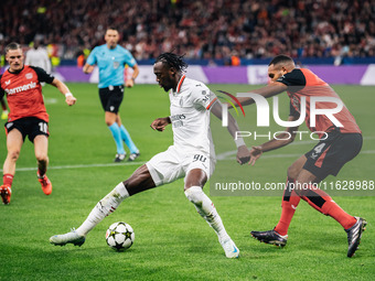 Tammy Abraham of AC Milan and Jonathan Tah of Bayer 04 Leverkusen are in action during the UEFA Champions League 2024/25 League Phase MD2 ma...