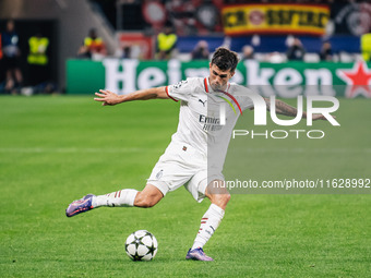 Christian Pulisic of AC Milan shoots the ball during the UEFA Champions League 2024/25 League Phase MD2 match between Bayer 04 Leverkusen an...