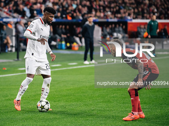 Alejandro Grimaldo of Bayer 04 Leverkusen and Emerson of AC Milan are in action during the UEFA Champions League 2024/25 League Phase MD2 ma...