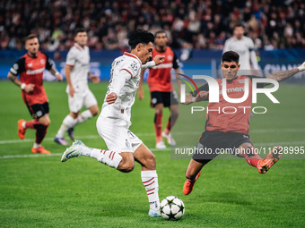 Tijjani Reijnders of AC Milan and Piero Hincapie of Bayer 04 Leverkusen are in action during the UEFA Champions League 2024/25 League Phase...