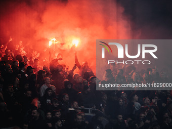 Fans of AC Milan light pyros during the UEFA Champions League 2024/25 League Phase MD2 match between Bayer 04 Leverkusen and AC Milan at Bay...