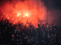 Fans of AC Milan light pyros during the UEFA Champions League 2024/25 League Phase MD2 match between Bayer 04 Leverkusen and AC Milan at Bay...