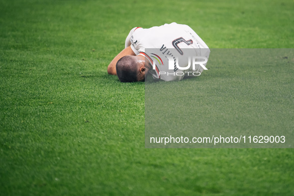 Alvaro Morata of AC Milan lies on the ground after getting tackled during the UEFA Champions League 2024/25 League Phase MD2 match between B...