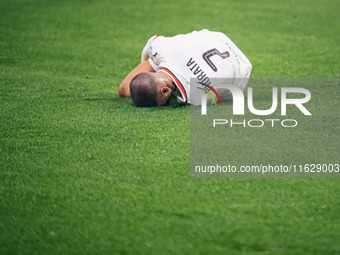 Alvaro Morata of AC Milan lies on the ground after getting tackled during the UEFA Champions League 2024/25 League Phase MD2 match between B...