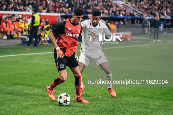 Emerson of AC Milan and Piero Hincapie of Bayer 04 Leverkusen are in action during the UEFA Champions League 2024/25 League Phase MD2 match...