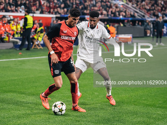 Emerson of AC Milan and Piero Hincapie of Bayer 04 Leverkusen are in action during the UEFA Champions League 2024/25 League Phase MD2 match...