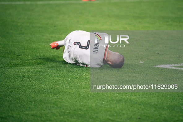 Alvaro Morata of AC Milan lies on the ground after getting tackled during the UEFA Champions League 2024/25 League Phase MD2 match between B...