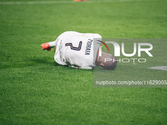 Alvaro Morata of AC Milan lies on the ground after getting tackled during the UEFA Champions League 2024/25 League Phase MD2 match between B...