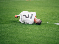 Alvaro Morata of AC Milan lies on the ground after getting tackled during the UEFA Champions League 2024/25 League Phase MD2 match between B...