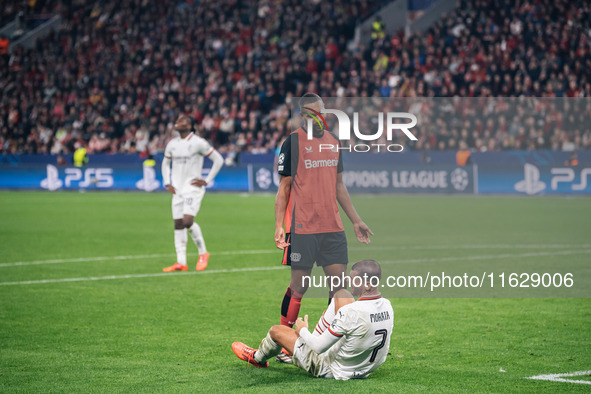 Jonathan Tah of Bayer 04 Leverkusen speaks to Alvaro Morata of AC Milan during the UEFA Champions League 2024/25 League Phase MD2 match betw...