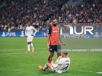 Jonathan Tah of Bayer 04 Leverkusen speaks to Alvaro Morata of AC Milan during the UEFA Champions League 2024/25 League Phase MD2 match betw...