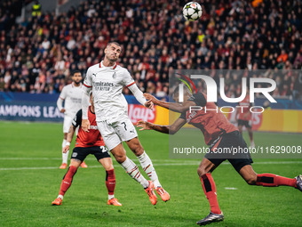 Alvaro Morata of AC Milan and Jonathan Tah of Bayer 04 Leverkusen are in action during the UEFA Champions League 2024/25 League Phase MD2 ma...