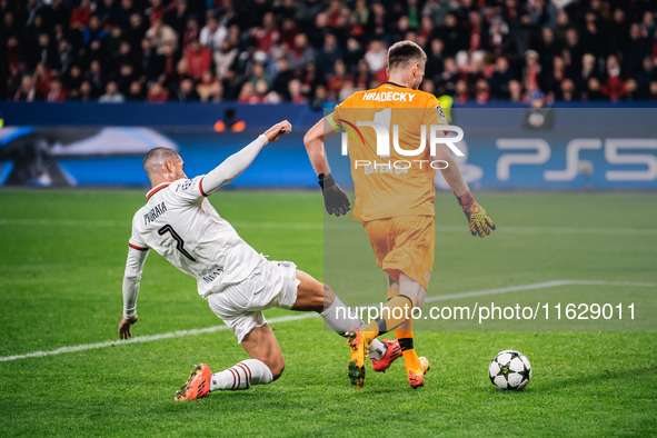 Alvaro Morata of AC Milan and Lukas Hradecky of Bayer 04 Leverkusen are in action during the UEFA Champions League 2024/25 League Phase MD2...