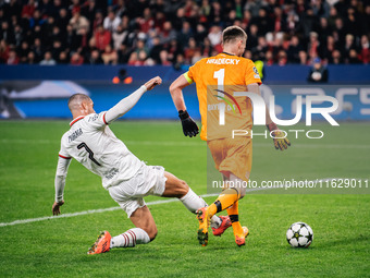 Alvaro Morata of AC Milan and Lukas Hradecky of Bayer 04 Leverkusen are in action during the UEFA Champions League 2024/25 League Phase MD2...