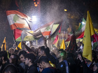 Iranians wave Lebanese flags and the Iranian flag while celebrating Iran's missile attack against Israel in Tehran, Iran, on October 1, 2024...