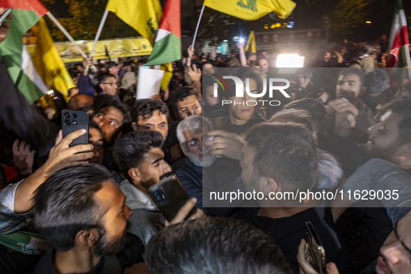 Saeed Jalili, Iranian politician and diplomat, opens his way through the people celebrating Iran's missile attack against Israel, in Tehran,...