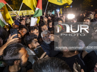 Saeed Jalili, Iranian politician and diplomat, opens his way through the people celebrating Iran's missile attack against Israel, in Tehran,...