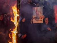 Iranian women hold portraits of Lebanon's Hezbollah Secretary General, Hassan Nasrallah, and former commander of the Islamic Revolutionary G...