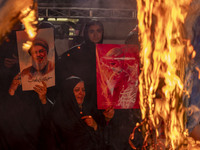 Iranian women hold portraits of Lebanon's Hezbollah Secretary General, Hassan Nasrallah, and former commander of the Islamic Revolutionary G...