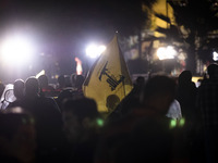 An Iranian man (not pictured) waves a flag of Lebanon's Hezbollah while celebrating Iran's missile attack against Israel in Tehran, Iran, on...