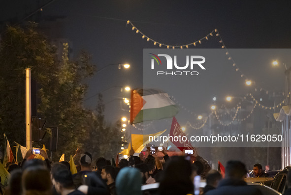 An Iranian man (not pictured) waves a Palestinian flag while celebrating Iran's missile attack against Israel in Tehran, Iran, on October 1,...