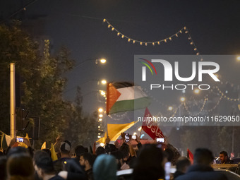 An Iranian man (not pictured) waves a Palestinian flag while celebrating Iran's missile attack against Israel in Tehran, Iran, on October 1,...