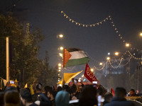 An Iranian man (not pictured) waves a Palestinian flag while celebrating Iran's missile attack against Israel in Tehran, Iran, on October 1,...