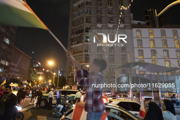 A young Iranian boy waves a Palestinian flag while celebrating Iran's missile attack against Israel in Tehran, Iran, on October 1, 2024. Ira...