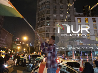 A young Iranian boy waves a Palestinian flag while celebrating Iran's missile attack against Israel in Tehran, Iran, on October 1, 2024. Ira...