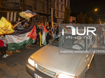 Iranians wave Palestinian flags while celebrating Iran's missile attack against Israel in Tehran, Iran, on October 1, 2024. Iran launches hu...