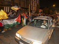 Iranians wave Palestinian flags while celebrating Iran's missile attack against Israel in Tehran, Iran, on October 1, 2024. Iran launches hu...