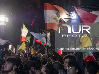 Iranians wave Lebanese and Palestinian flags while celebrating Iran's missile attack against Israel in Tehran, Iran, on October 1, 2024. Ira...