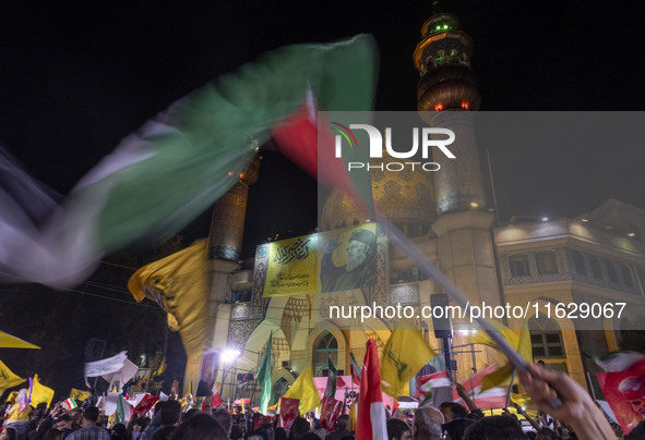 Iranians wave flags while celebrating Iran's missile attack against Israel in Tehran, Iran, on October 1, 2024. Iran launches hundreds of ba...