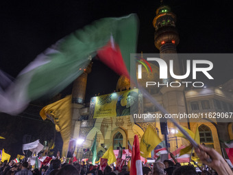 Iranians wave flags while celebrating Iran's missile attack against Israel in Tehran, Iran, on October 1, 2024. Iran launches hundreds of ba...