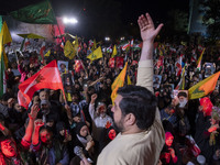 Iranians wave flags and shout anti-Israeli and anti-U.S. slogans while celebrating Iran's missile attack against Israel in Tehran, Iran, on...