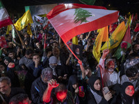 Iranians wave flags and shout anti-Israeli and anti-U.S. slogans while celebrating Iran's missile attack against Israel in Tehran, Iran, on...