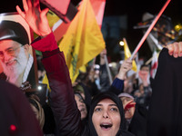 An Iranian woman shouts anti-Israeli slogans while standing next to a portrait of Iran's Supreme Leader, Ayatollah Ali Khamenei, as she take...