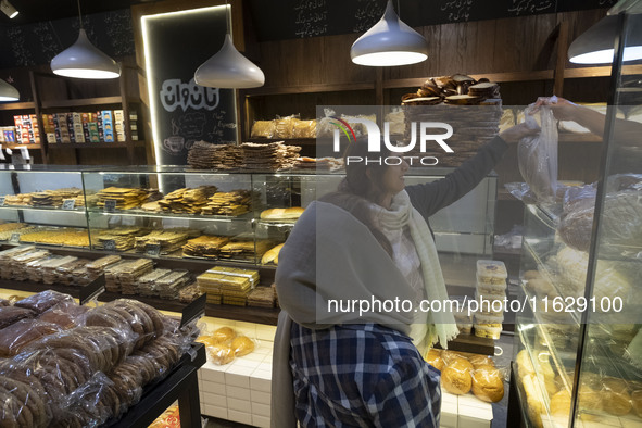 Two Iranian women shop for bread at a bakery in downtown Tehran, Iran, on October 1, 2024, after Iran's missile attack against Israel. Iran...