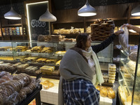 Two Iranian women shop for bread at a bakery in downtown Tehran, Iran, on October 1, 2024, after Iran's missile attack against Israel. Iran...