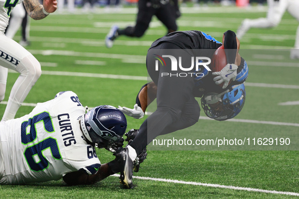 DETROIT,MICHIGAN-September 30: Detroit Lions cornerback Khalil Dorsey (30) runs the ball against Seattle Seahawks offensive tackle McClendon...