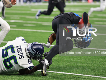 DETROIT,MICHIGAN-September 30: Detroit Lions cornerback Khalil Dorsey (30) runs the ball against Seattle Seahawks offensive tackle McClendon...