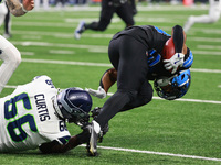 DETROIT,MICHIGAN-September 30: Detroit Lions cornerback Khalil Dorsey (30) runs the ball against Seattle Seahawks offensive tackle McClendon...