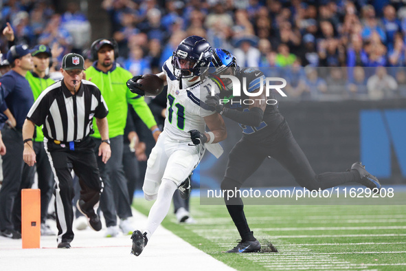 DETROIT,MICHIGAN-September 30: Seattle Seahawks wide receiver Jaxon Smith-Njigba (11) runs the ball against Detroit Lions cornerback Amik Ro...